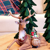 Rena decorativa com saco de presentes
